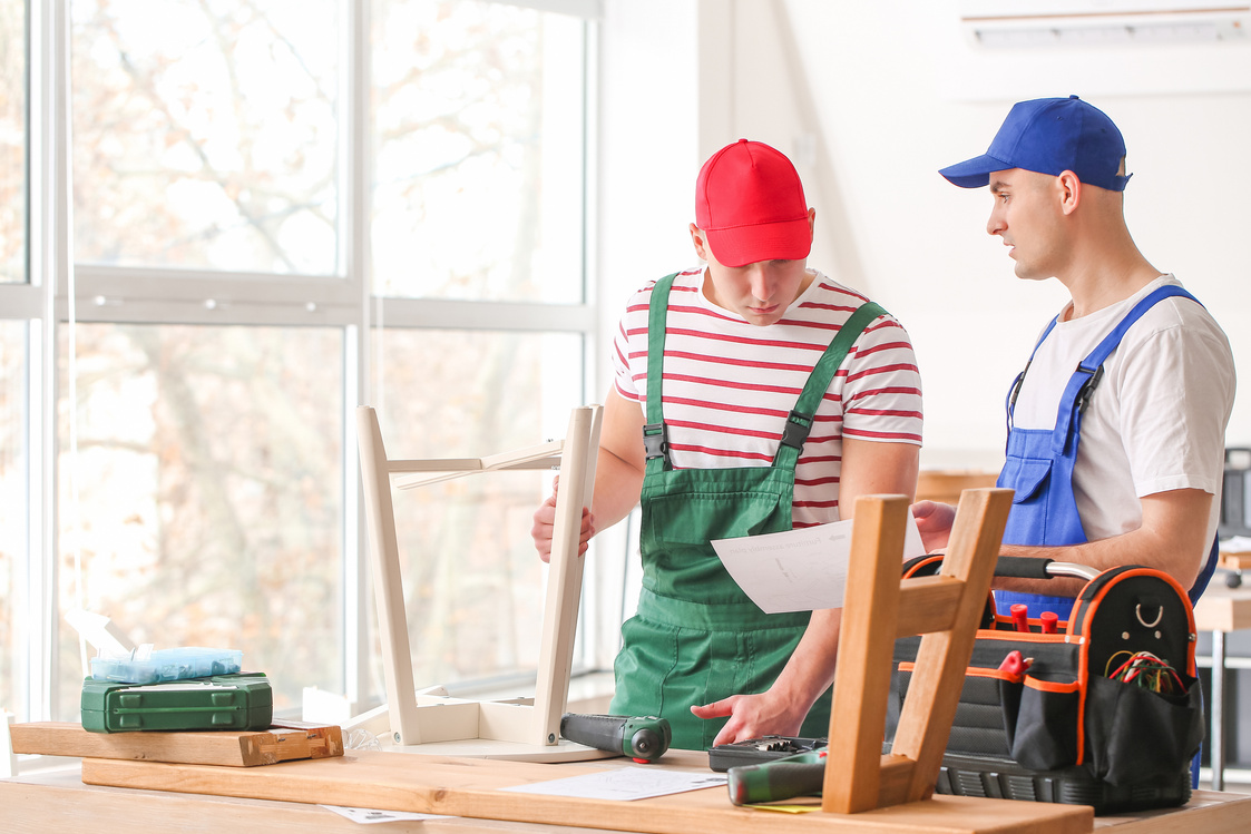 Handymen Assembling Furniture in Workshop