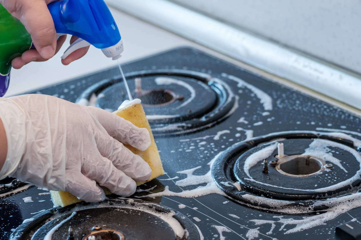 Person Cleaning a Stove